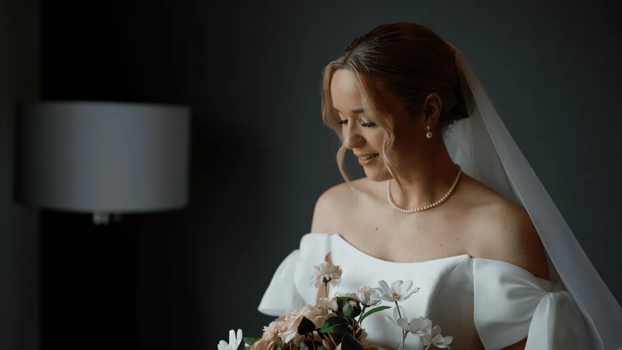 Erin by window light, holding her bouquet