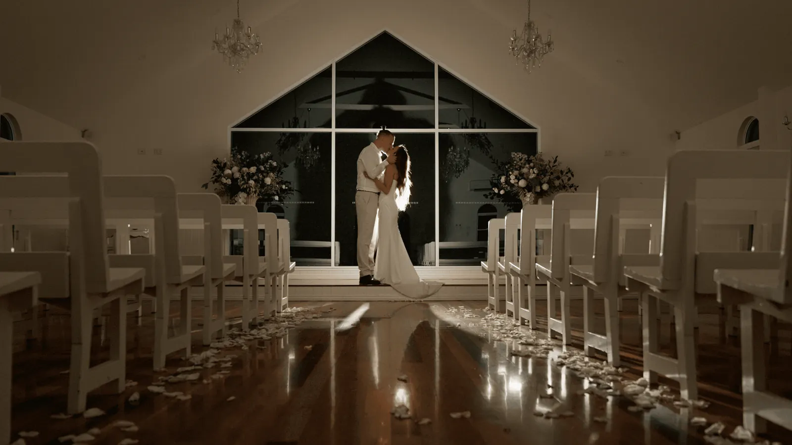 Olivia and Wayne in the chapel at Tiffany’s Maleny, before a tall window